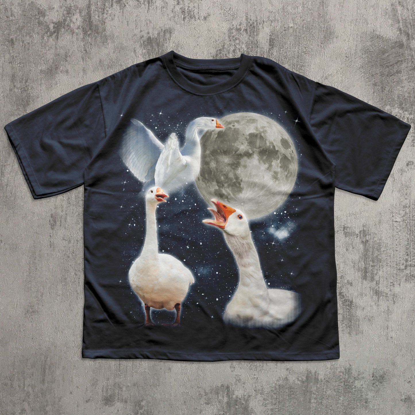 Black t-shirt with a graphic of three geese and a moon on a concrete surface
