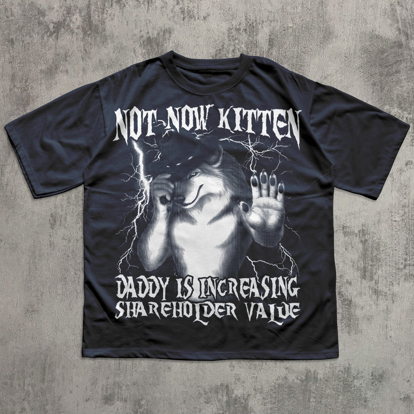 Black t-shirt with graphic design and text on a textured gray background