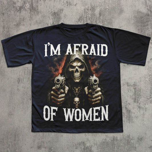 Black t-shirt with a graphic of a skeleton holding guns and text 'I'm Afraid of Women' on a concrete surface.
