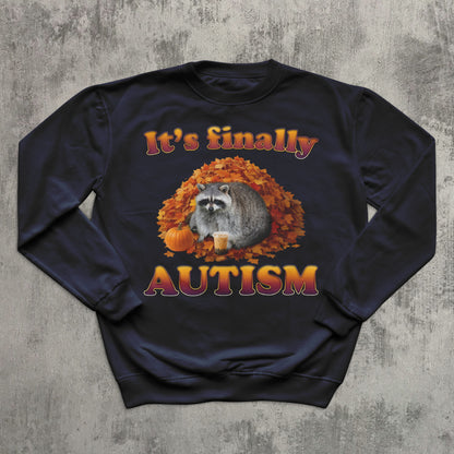 Navy blue sweatshirt with raccoon and autumn design on a textured gray background