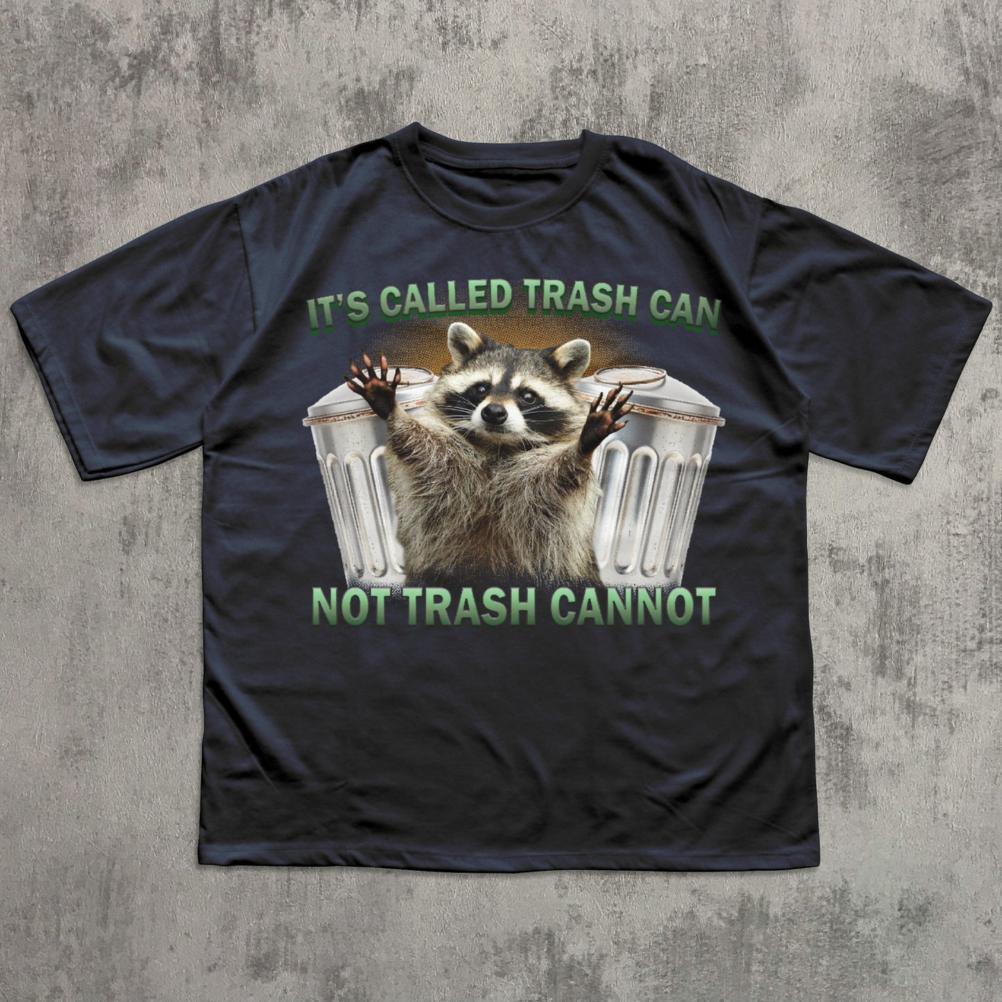 Black t-shirt with a raccoon graphic and text on a textured gray background