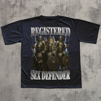 Black t-shirt with warrior graphic and text 'REGISTERED SEX DEFENDER' on a textured gray background