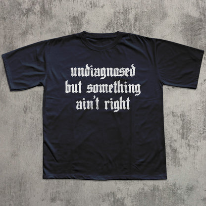 Black t-shirt with white text on a textured gray background