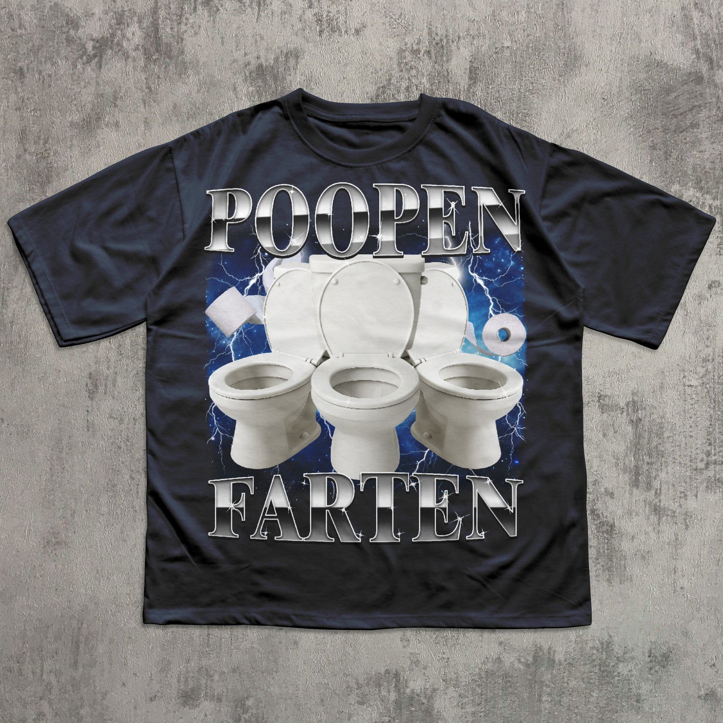 Black t-shirt with a graphic of three toilets and the text 'POOPEN FARTEN' on a concrete surface.