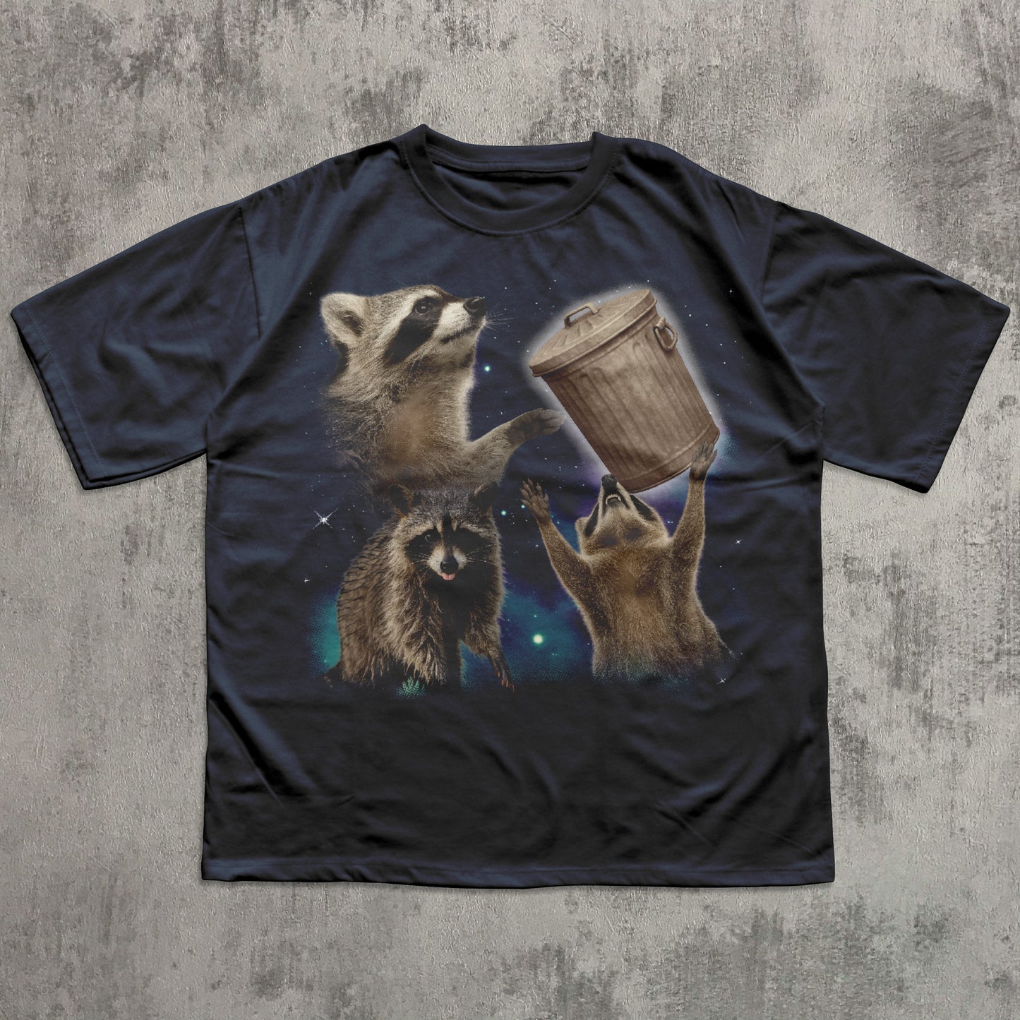 Black funny t-shirt with raccoon graphic on a textured gray background