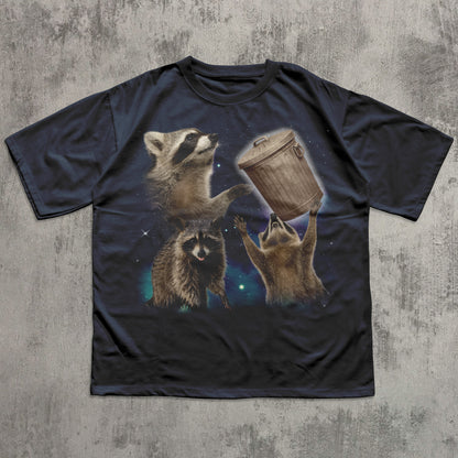 Black funny t-shirt with raccoon graphic on a textured gray background