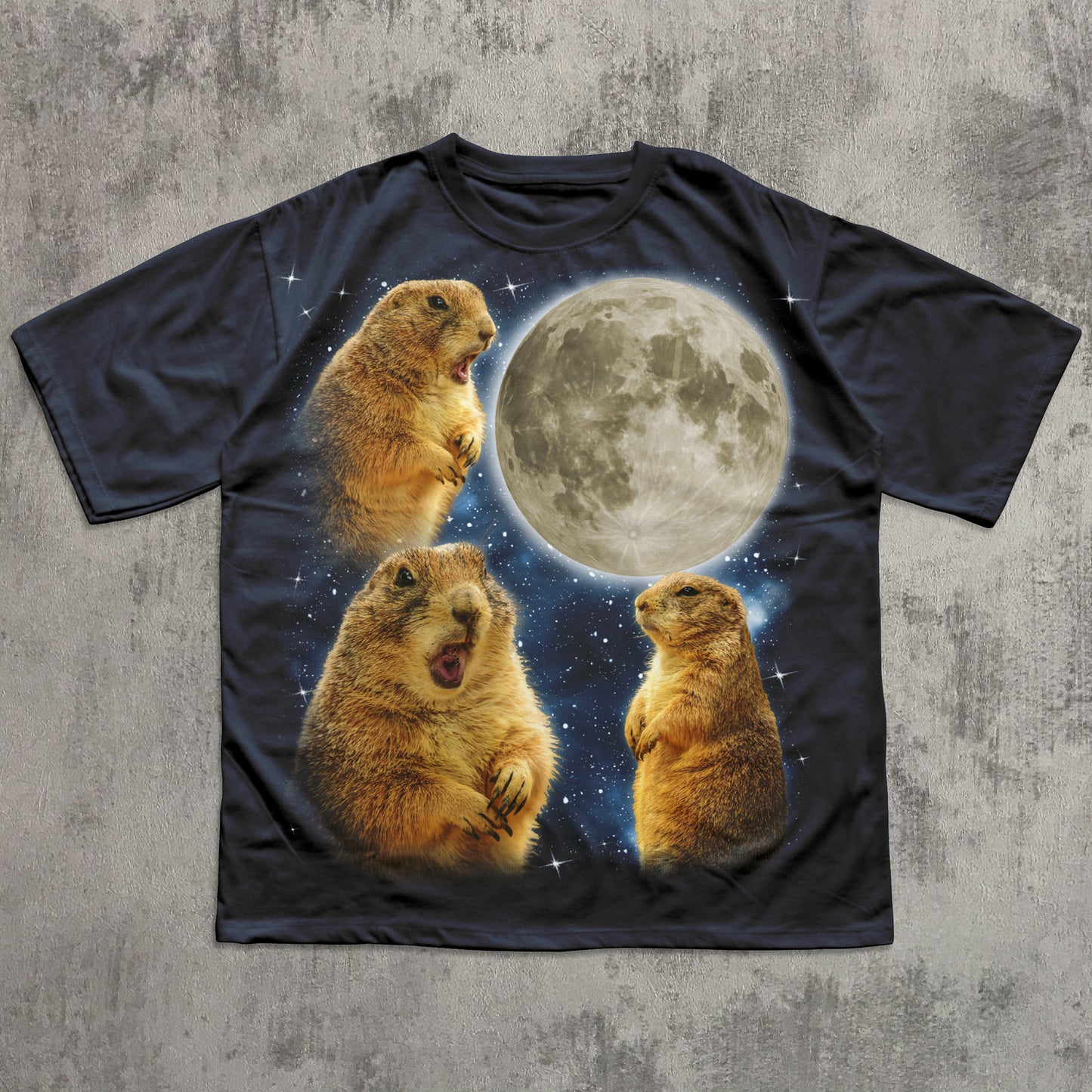 Black t-shirt with prairie dogs and a moon graphic on a textured gray background