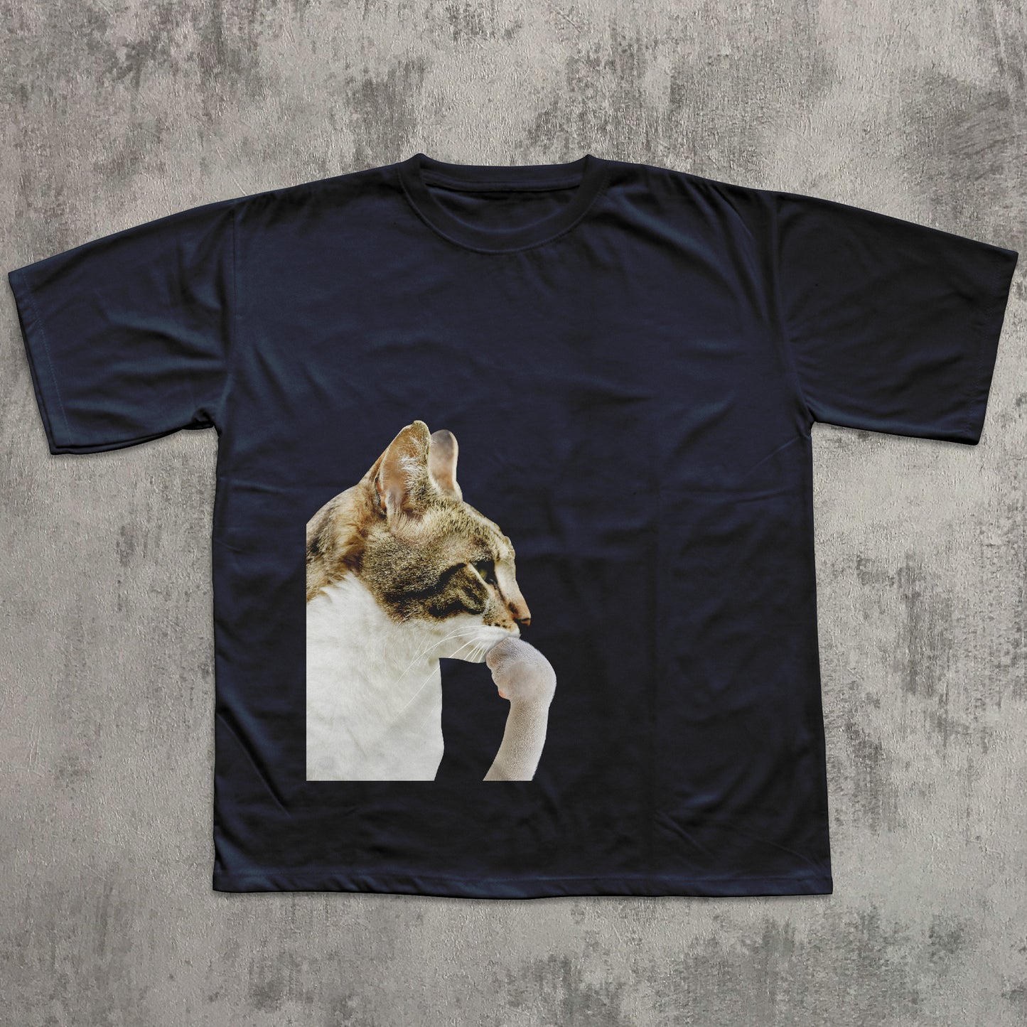 Black t-shirt with a cat graphic on a textured gray background