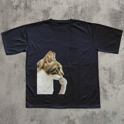 Black t-shirt with a cat graphic on a textured gray background