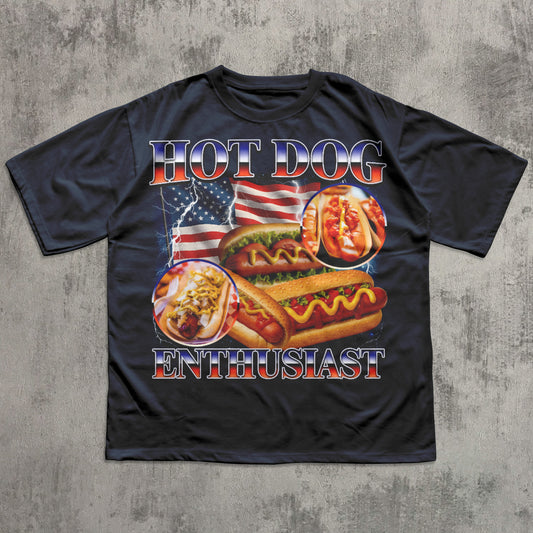 Black t-shirt with hot dog graphic and 'Hot Dog Enthusiast' text on a textured gray background