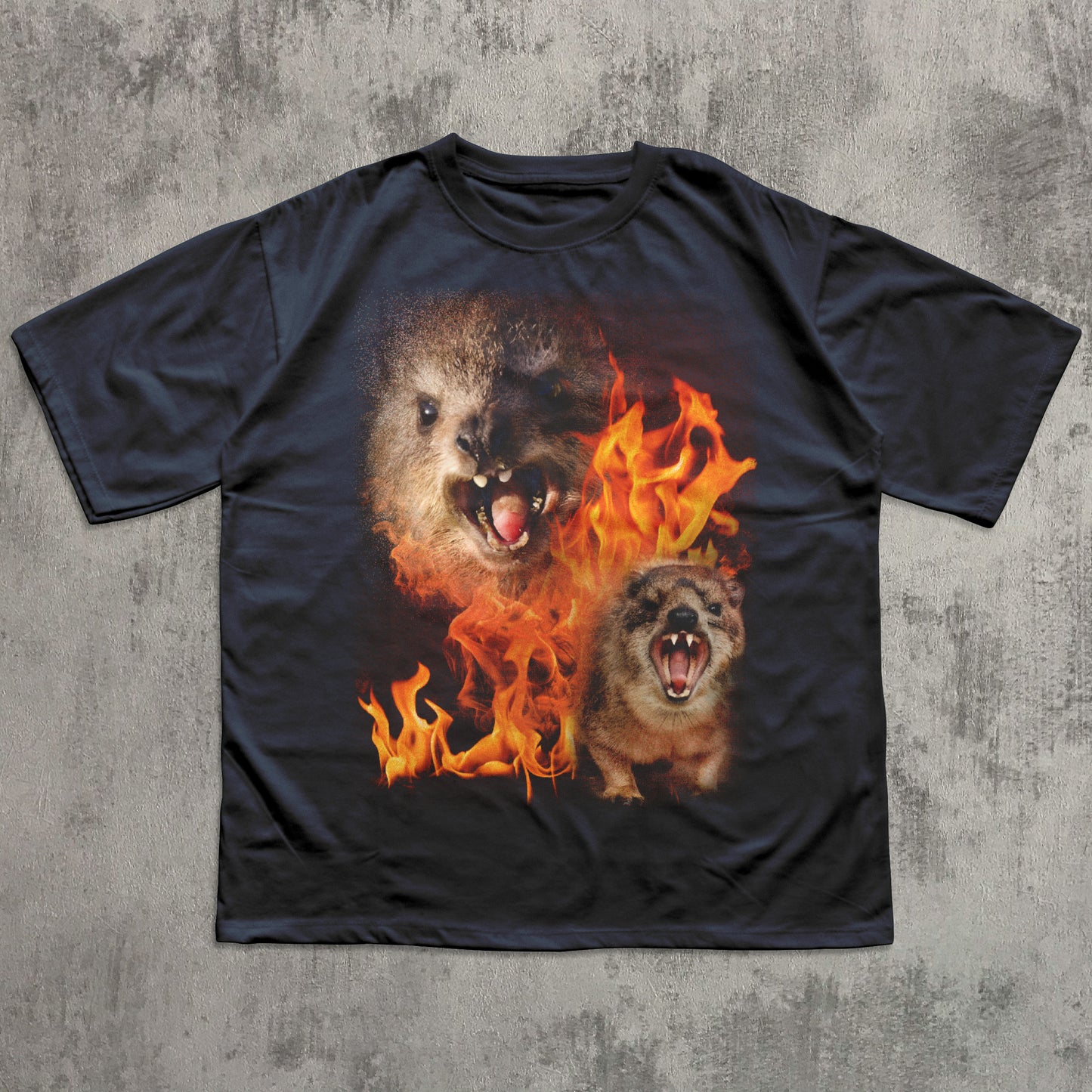 Black t-shirt with a graphic of two hyraxes in flames on a textured gray background