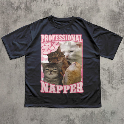 Funny Black t-shirt with a graphic of cats and 'Professional Napper' text on a textured gray background