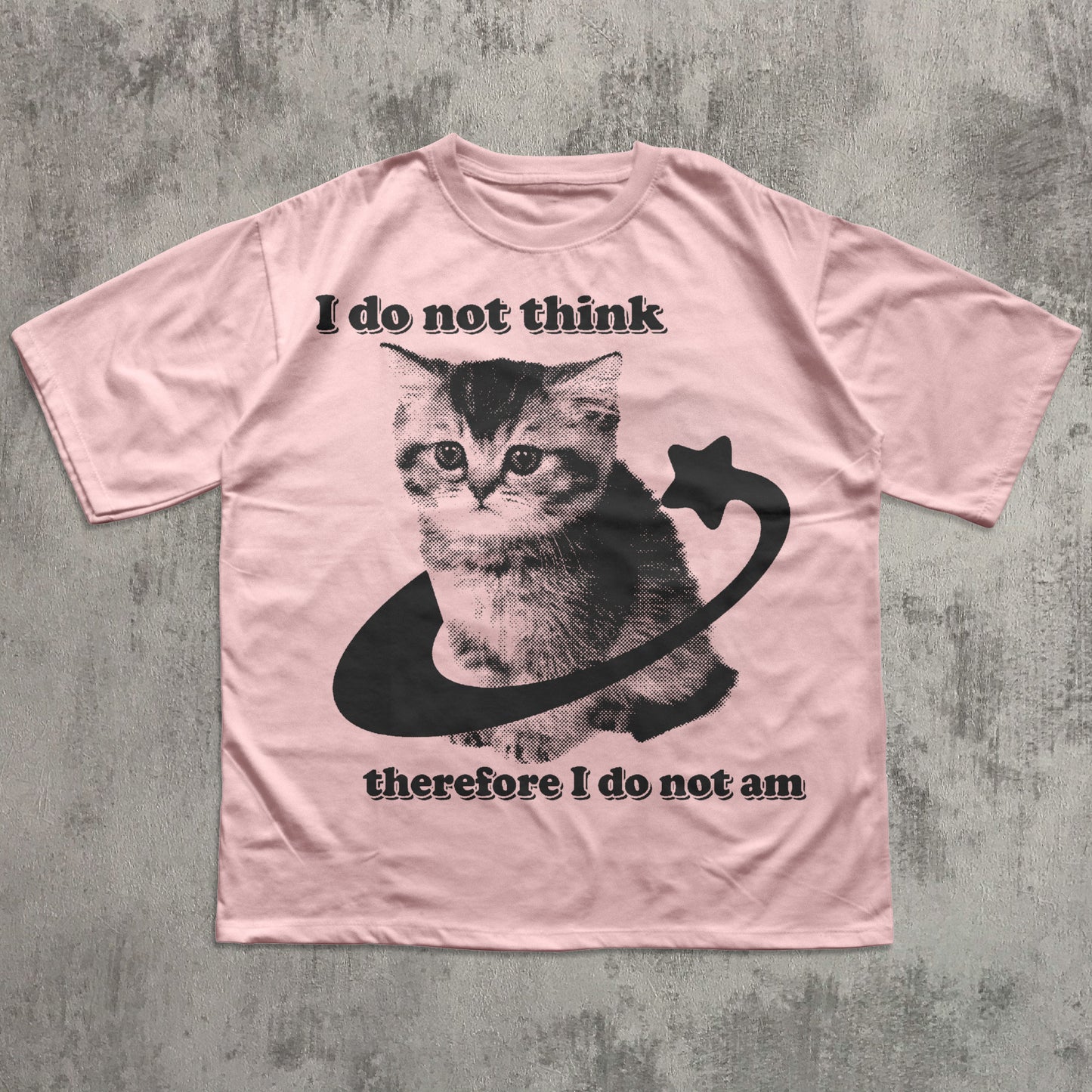 Pink t-shirt with a cat graphic and text on a textured gray background