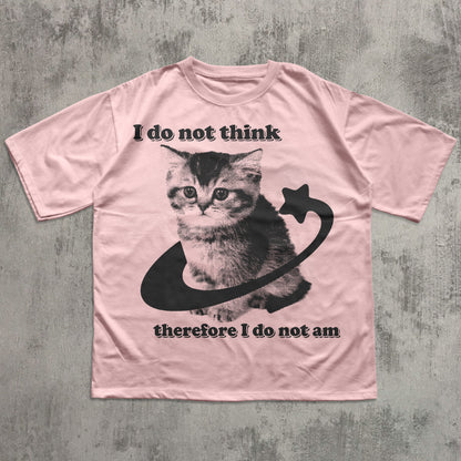 Pink t-shirt with a cat graphic and text on a textured gray background