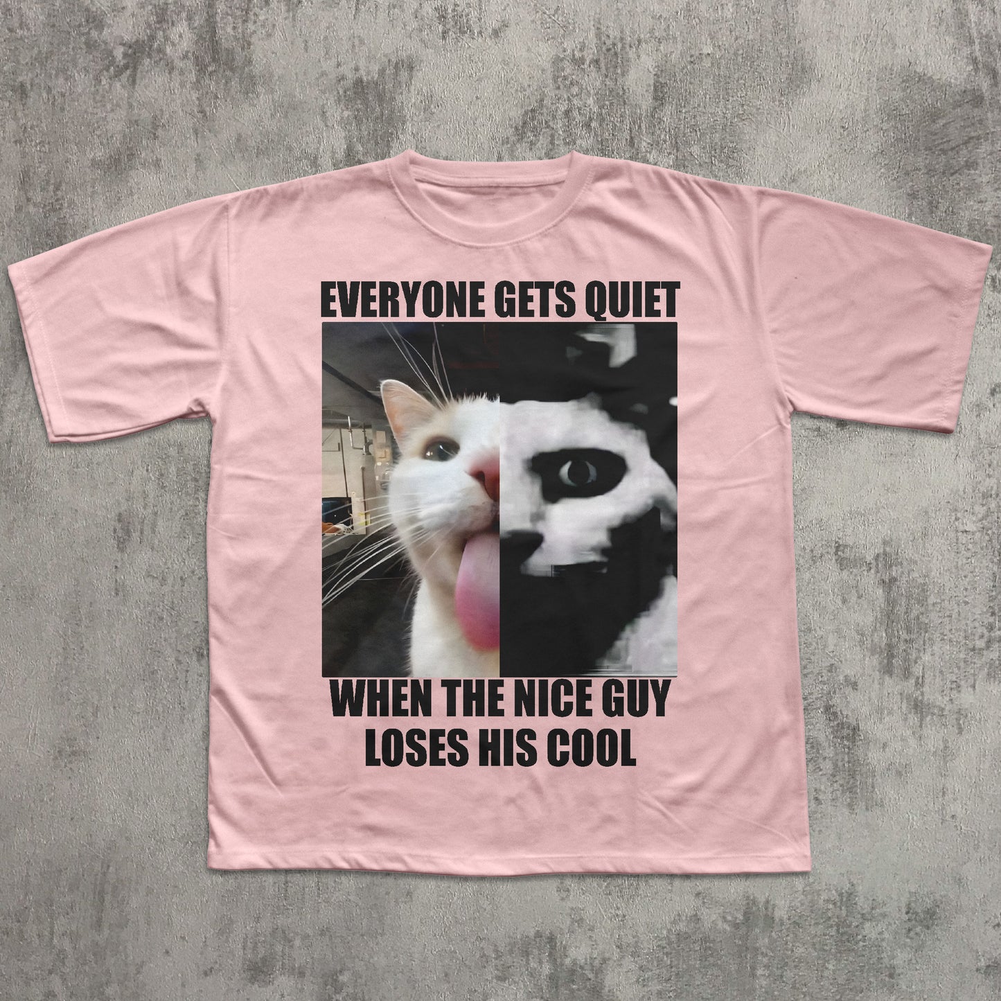 Pink t-shirt with a graphic of a cat and text on a concrete surface