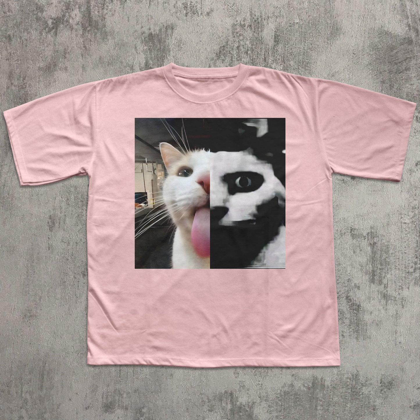 Pink t-shirt with a cat graphic on a textured gray background