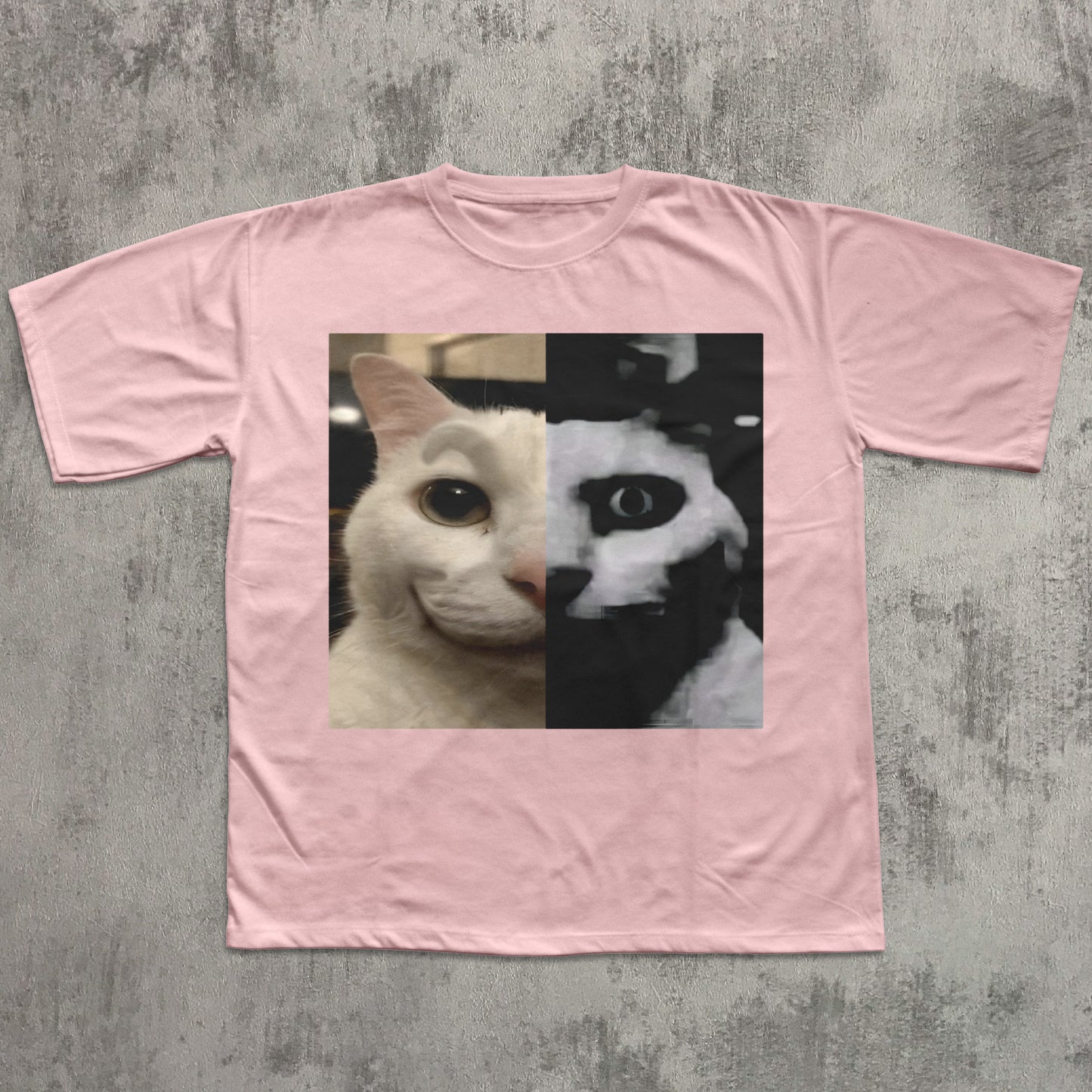 Pink t-shirt with a cat face design on a textured gray background