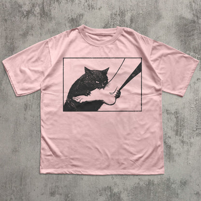 Dark humor cat graphic tee featuring black cat illustration biting foot, funny cat lover shirt