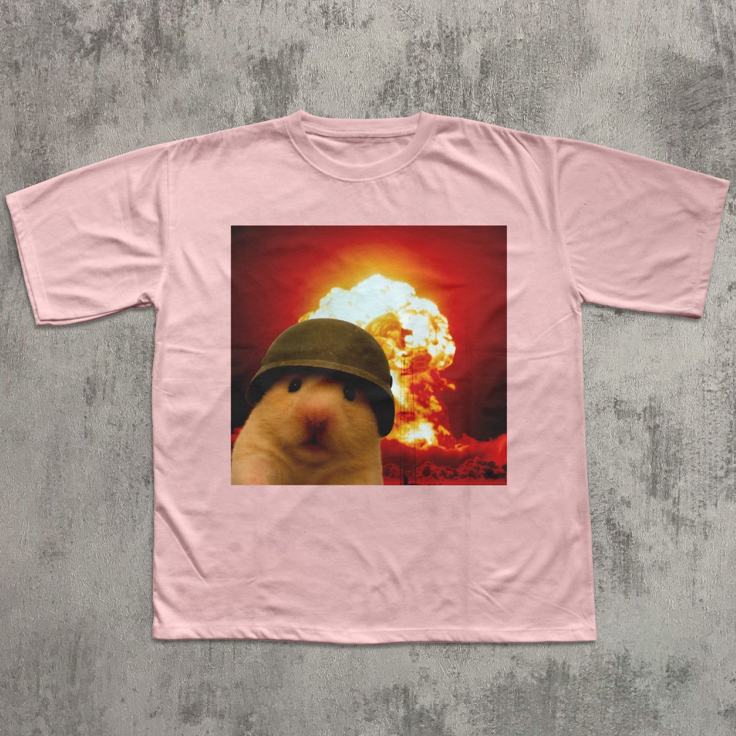 Pink t-shirt with a graphic of a hamster wearing a helmet in front of an explosion on a gray textured background
