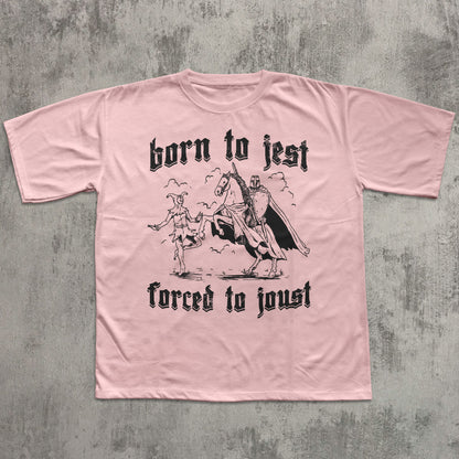 Pink t-shirt with black graphic and text on a textured gray background