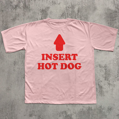 Pink t-shirt with red graphic and text 'Insert Hot Dog' on a gray textured background