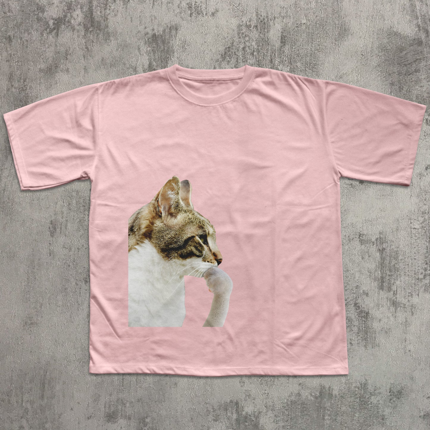 Pink t-shirt with a cat graphic on a textured gray background