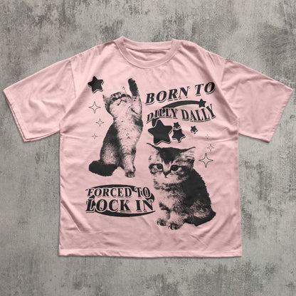 Pink t-shirt with black cat graphics and text on a textured gray background