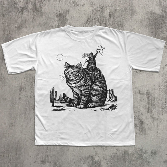White t-shirt with a black and white graphic of a cat and a skeleton on a concrete surface