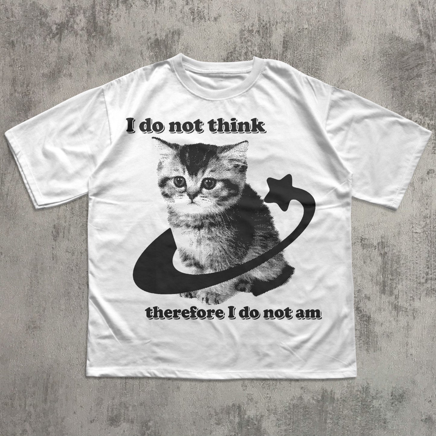 White t-shirt with a cat graphic and text on a concrete surface