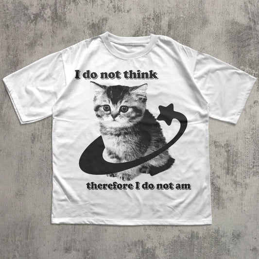 White t-shirt with a cat graphic and text on a concrete surface