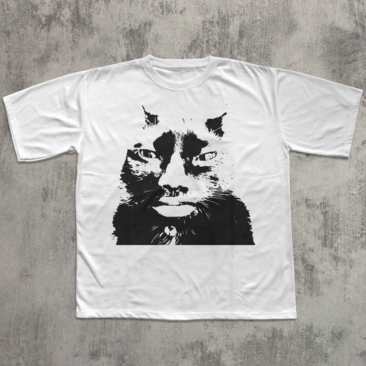White t-shirt with a black cat graphic on a gray textured background