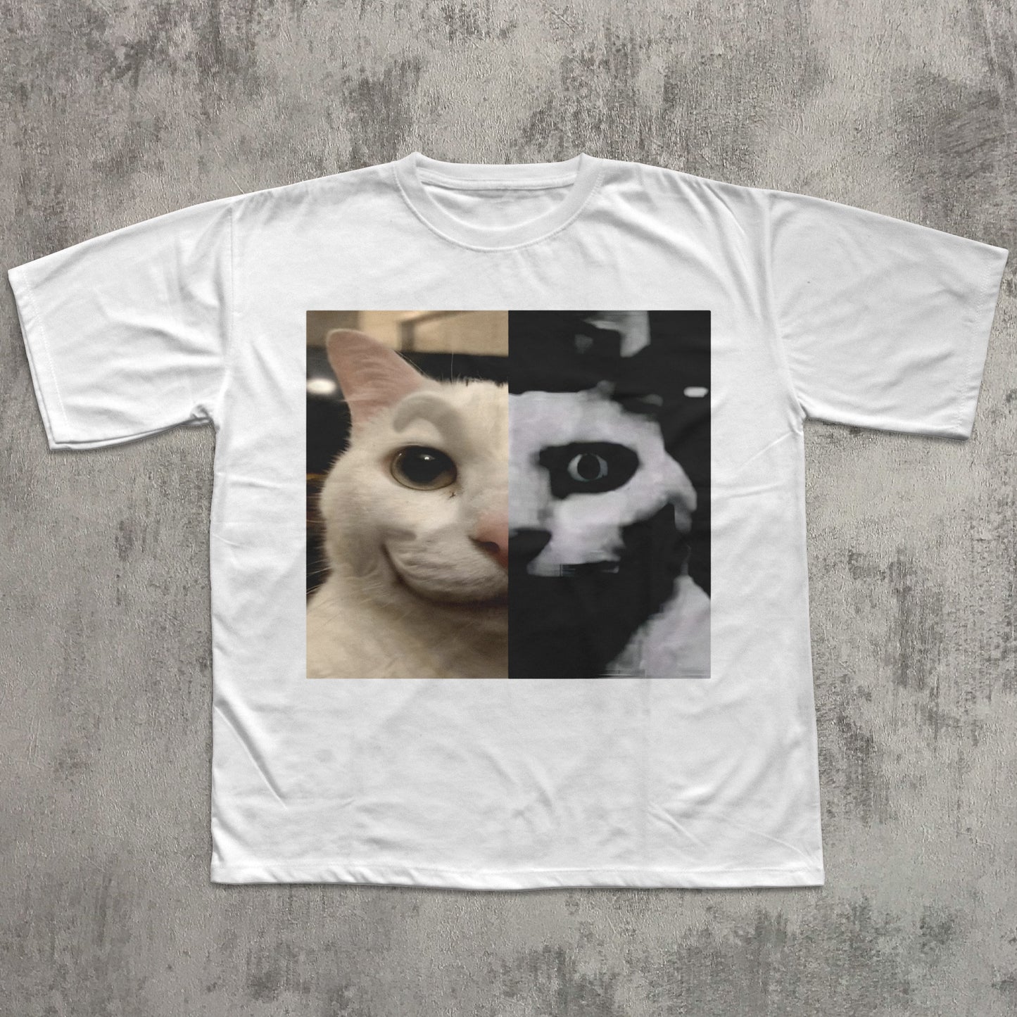White t-shirt with a cat face design on a textured gray background