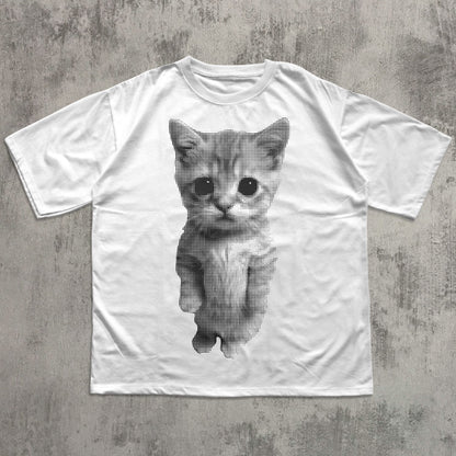 White t-shirt with a printed cat design on a concrete surface