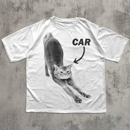 White t-shirt with a graphic of a cat and the word 'CAR' on a concrete surface
