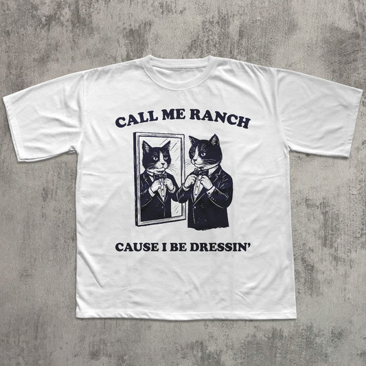 White t-shirt with black graphic and text on a gray concrete background