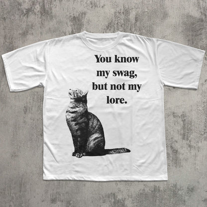 White t-shirt with a cat graphic and text on a textured gray background