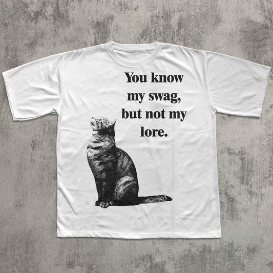 White t-shirt with a cat graphic and text on a textured gray background