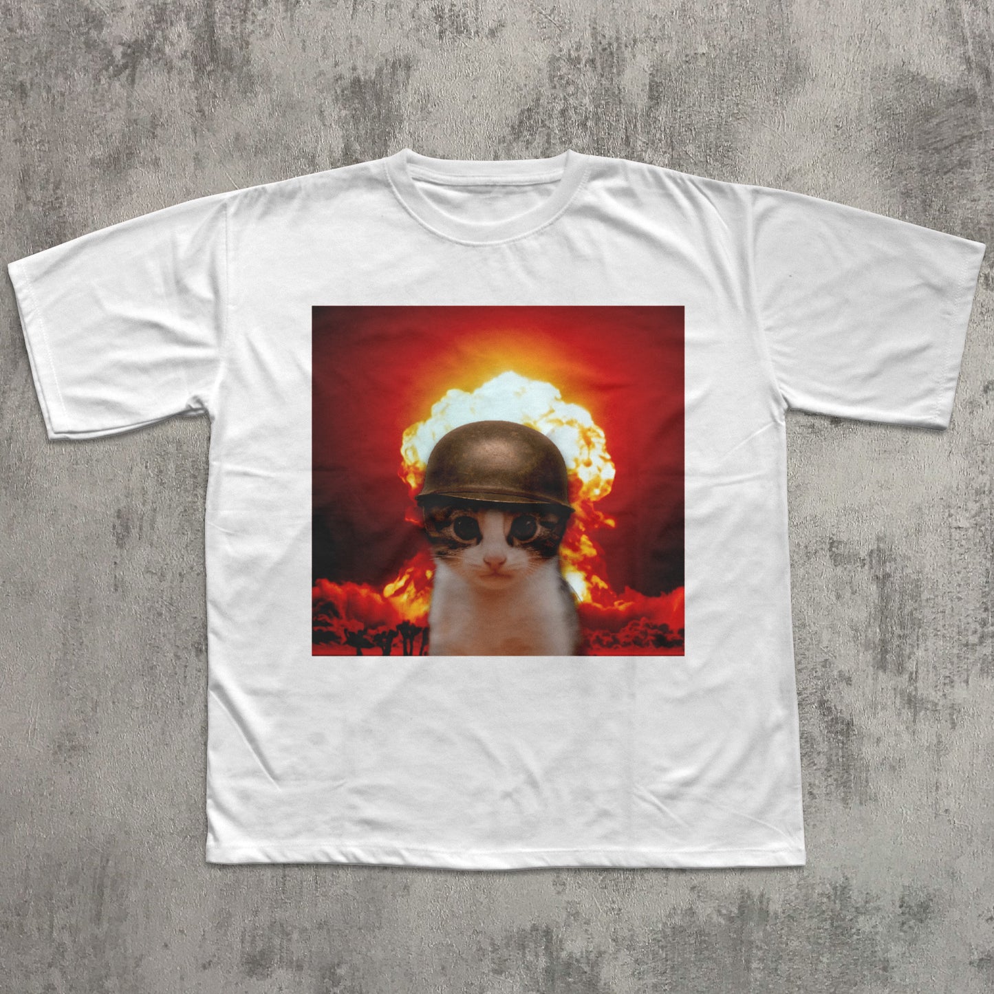 White t-shirt with a graphic of a cat wearing a helmet and goggles in front of an explosion on a concrete surface.