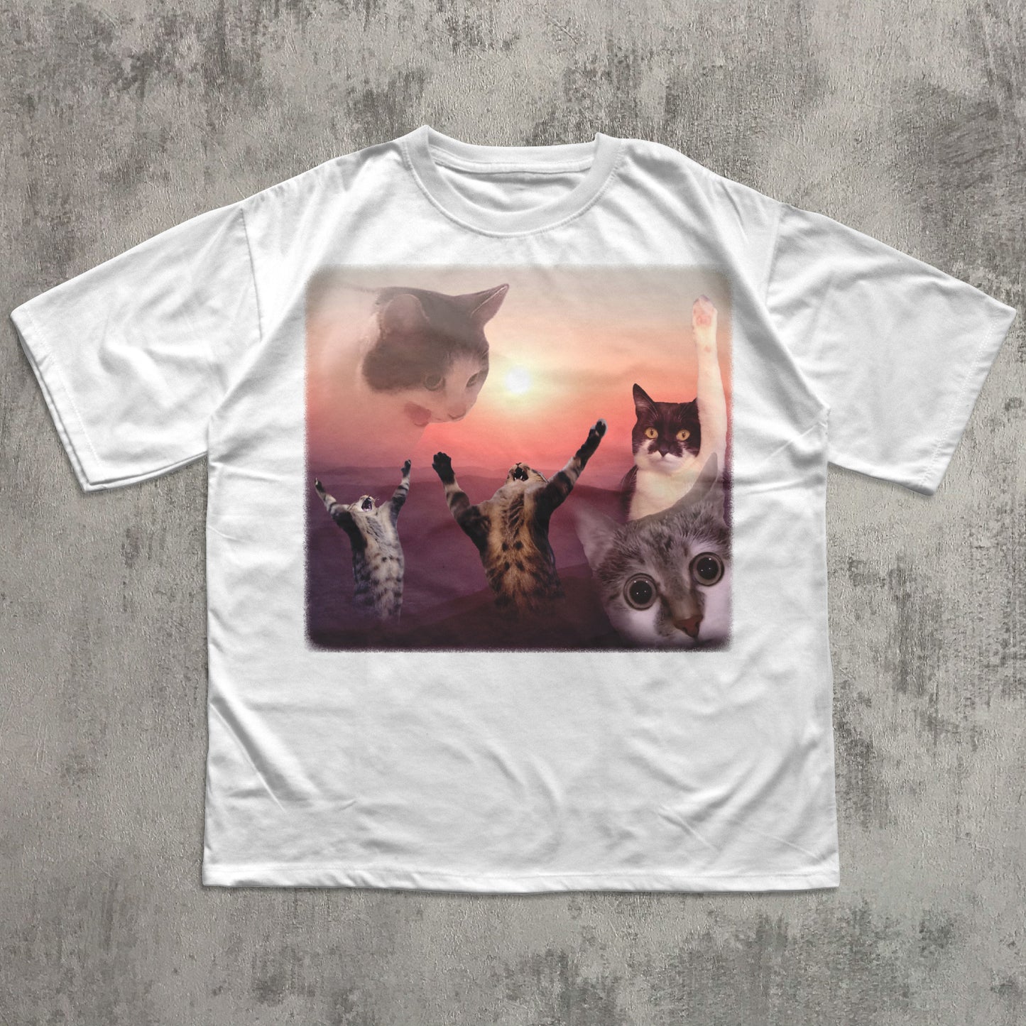 White t-shirt with a graphic of five cats at sunset on a concrete surface