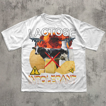 White t-shirt with graphic design featuring cows, cheese, and text on a concrete surface