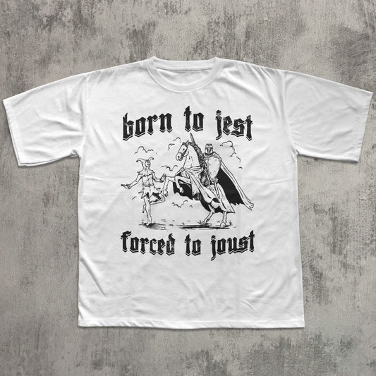 White t-shirt with black graphic and text 'born to jest, forced to joust' on a textured gray background