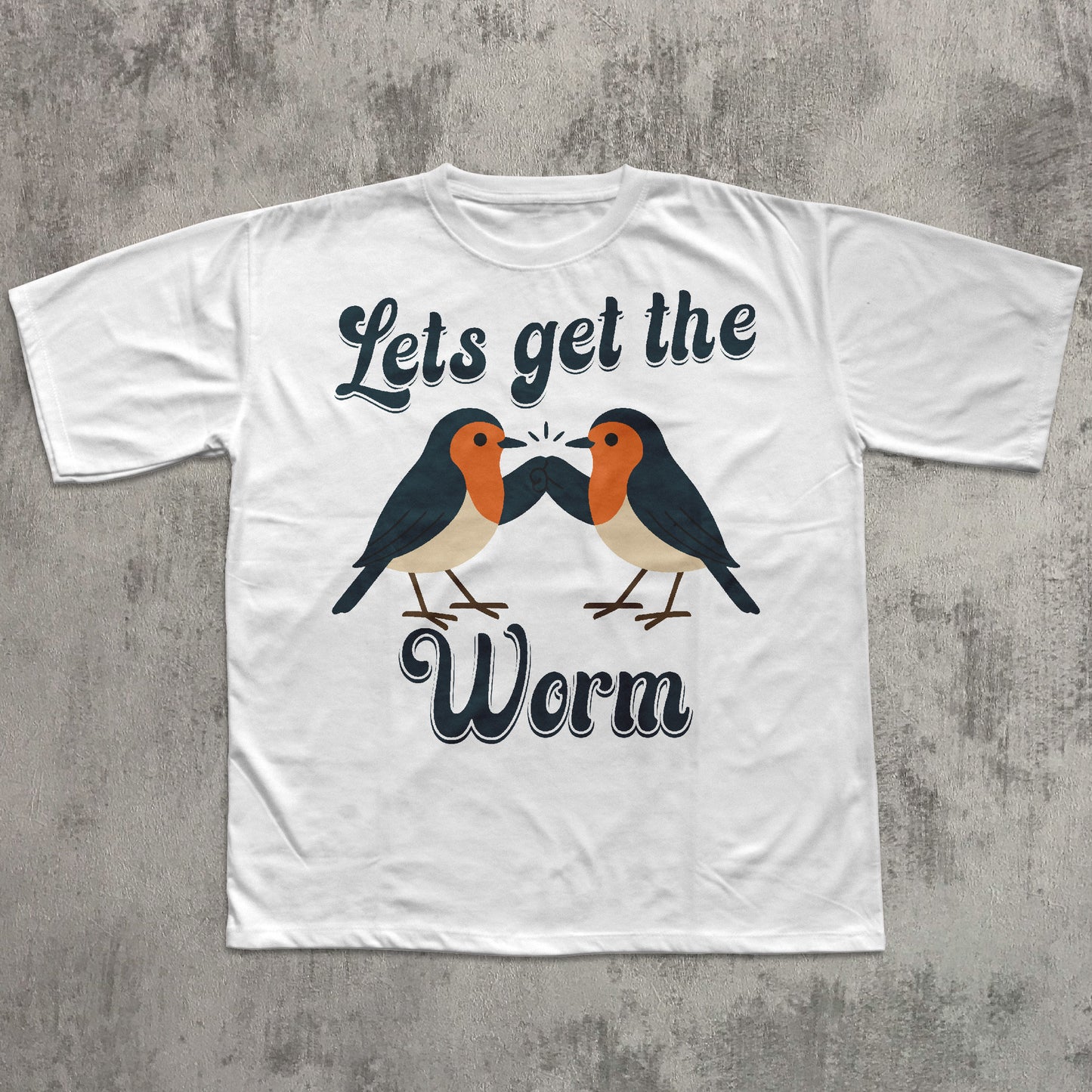 White t-shirt with two birds and text 'Let's get the Worm' on a concrete surface