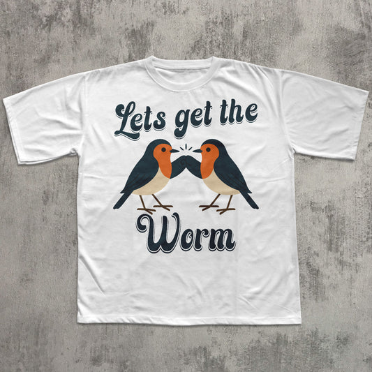 White t-shirt with two birds and text 'Let's get the Worm' on a concrete surface