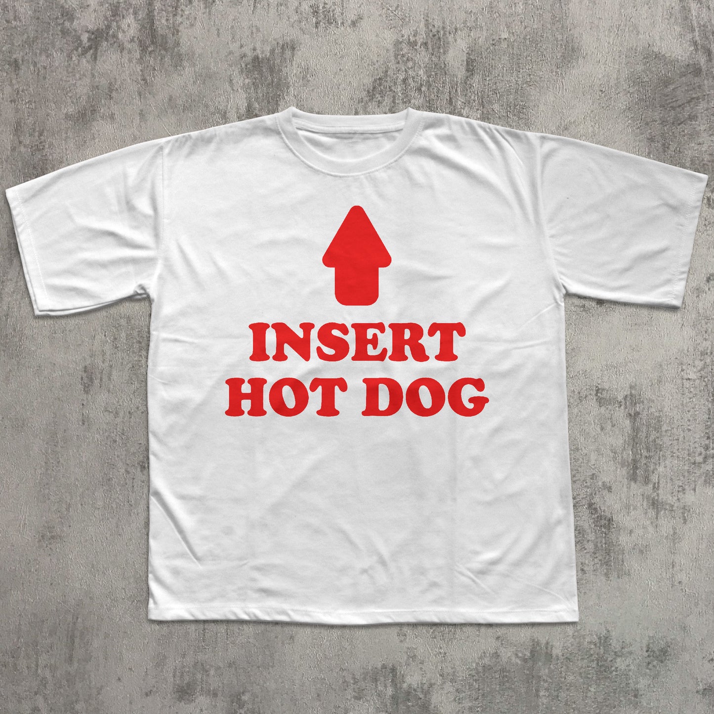 White t-shirt with red graphic and text 'Insert Hot Dog' on a gray concrete background