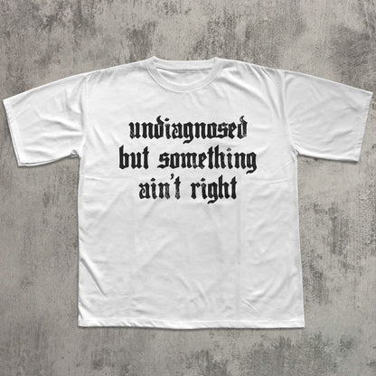 White t-shirt with black text on a gray concrete background