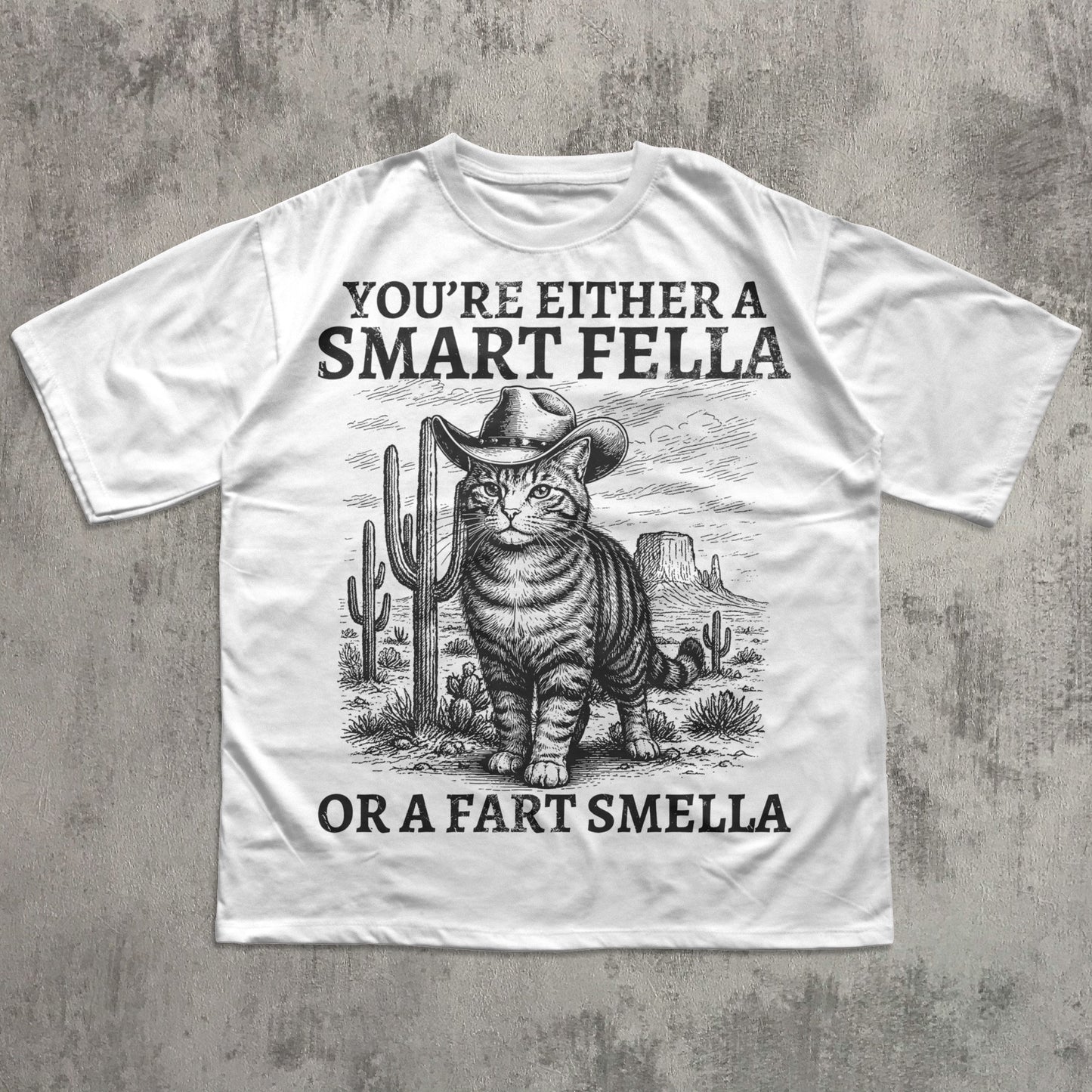 White t-shirt with a graphic of a cat in a cowboy hat and text on a concrete surface