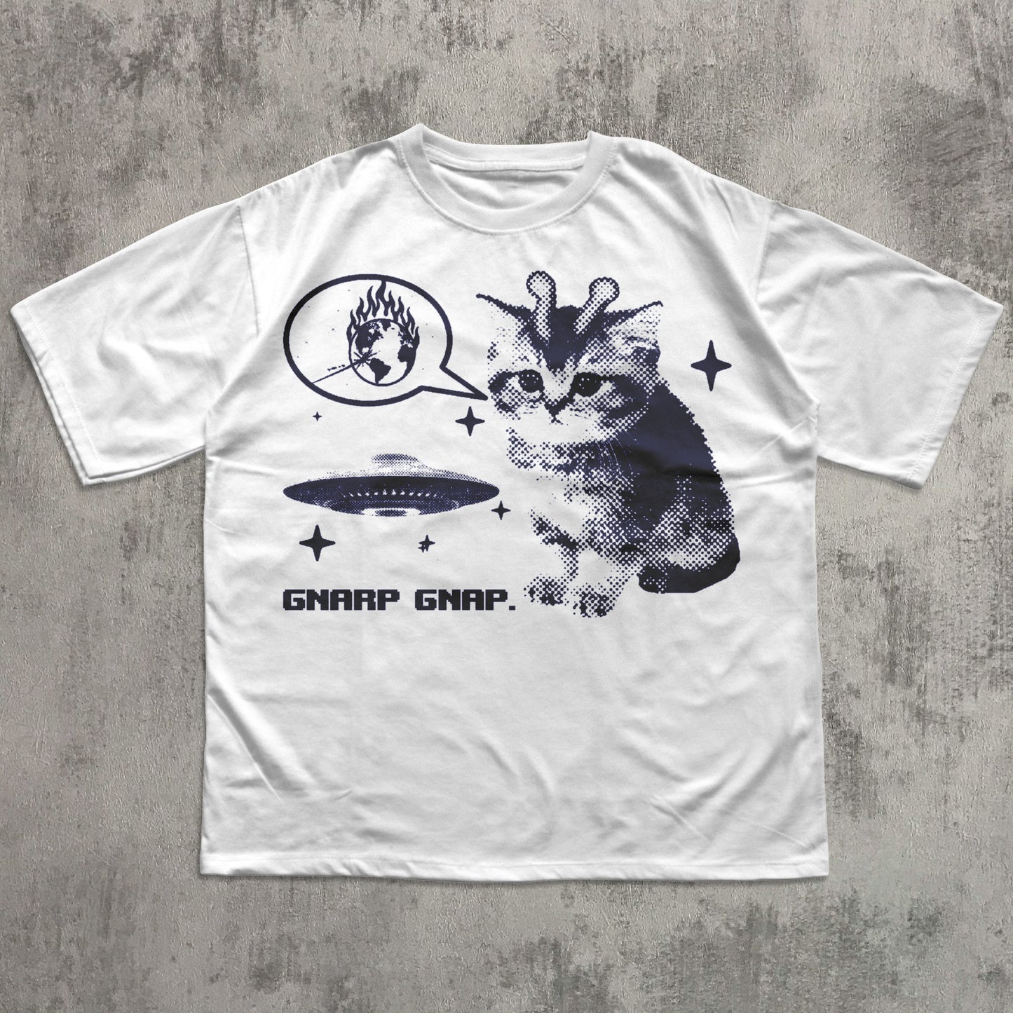 White t-shirt with a graphic of a cat and alien on a concrete surface