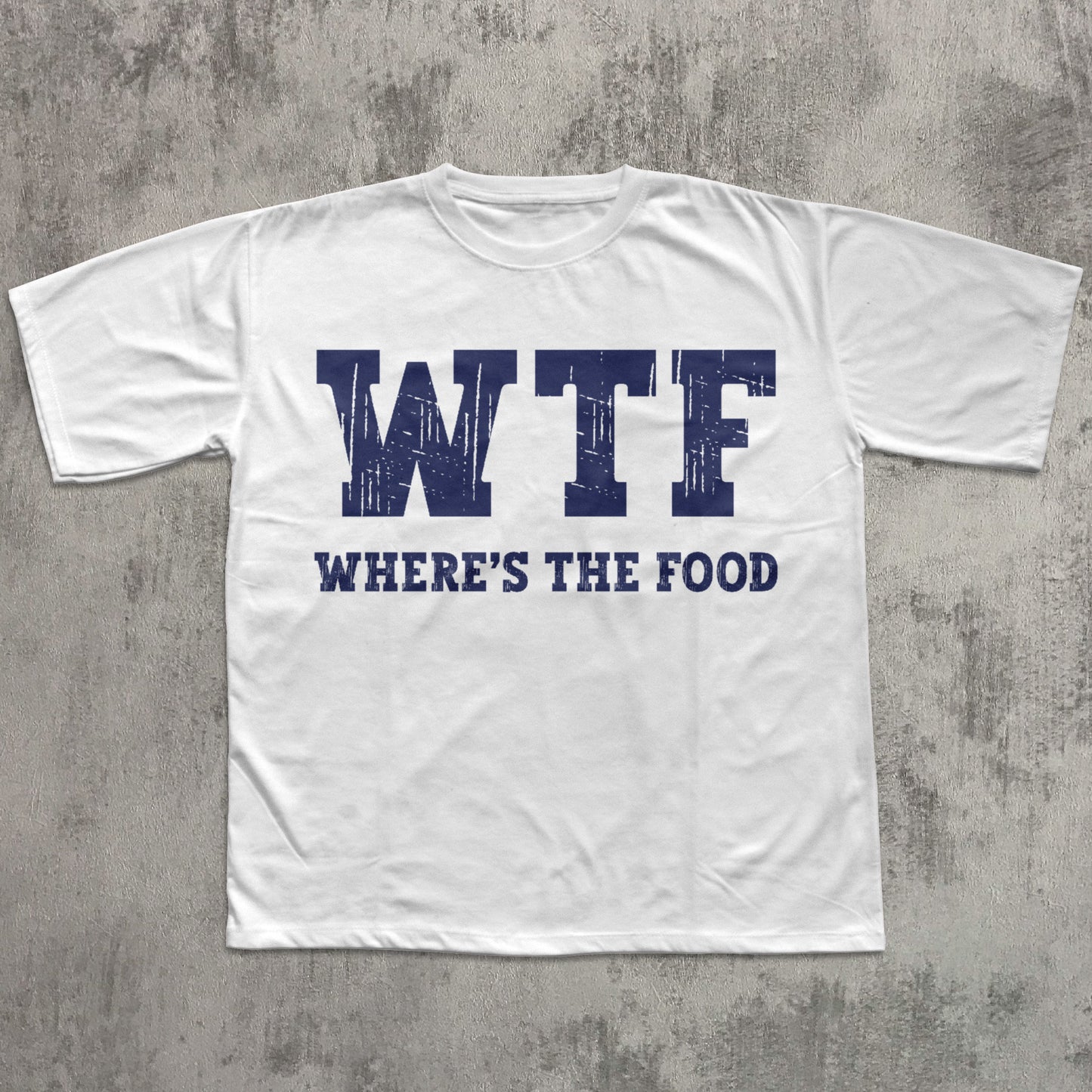 White t-shirt with 'WTF WHERE'S THE FOOD' text on a gray concrete background