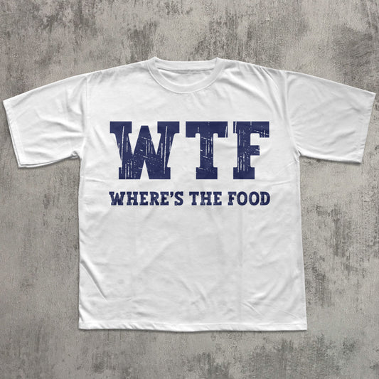 White t-shirt with 'WTF WHERE'S THE FOOD' text on a gray concrete background