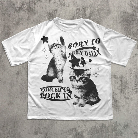 White t-shirt with black and white cat graphic and text on a gray concrete background